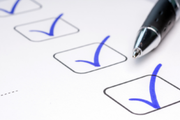 checklista z odznaczonymi na niebiesko boxami w sprawozdaniu przygotowanym przez Interzero; obok długopis